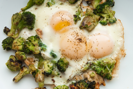 Fried eggs with broccoli and chicken meat. Healthy breakfast. Breakfast on a white plate.の写真素材