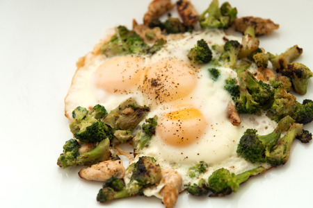 Fried eggs with broccoli and chicken meat. Healthy breakfast. Breakfast on a white plate.の写真素材