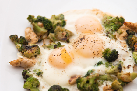 Fried eggs with broccoli and chicken meat. Healthy breakfast. Breakfast on a white plate.の写真素材