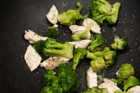 Broccoli fry in a pan with slices of meat. Chicken meat with broccoli. Useful breakfast.の写真素材