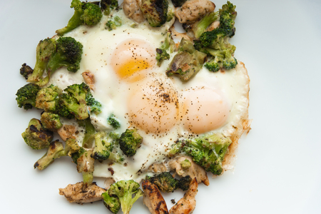 Fried eggs with broccoli and chicken meat. Healthy breakfast. Breakfast on a white plate.の写真素材