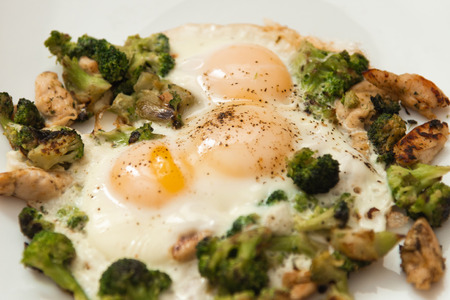 Fried eggs with broccoli and chicken meat. Healthy breakfast. Breakfast on a white plate.の写真素材