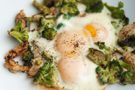 Fried eggs with broccoli and chicken meat. Healthy breakfast. Breakfast on a white plate.の写真素材