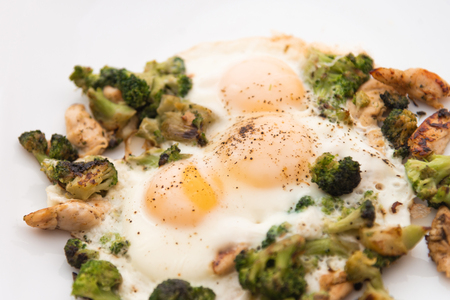 Fried eggs with broccoli and chicken meat. Healthy breakfast. Breakfast on a white plate.の写真素材