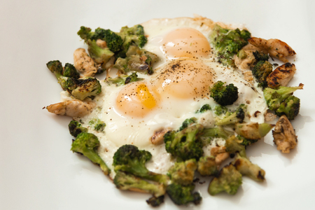 Fried eggs with broccoli and chicken meat. Healthy breakfast. Breakfast on a white plate.の写真素材