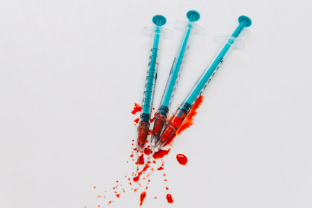 Treatment against addiction. Syringe with blood. Immunodeficiency. Treatment of addictionの写真素材