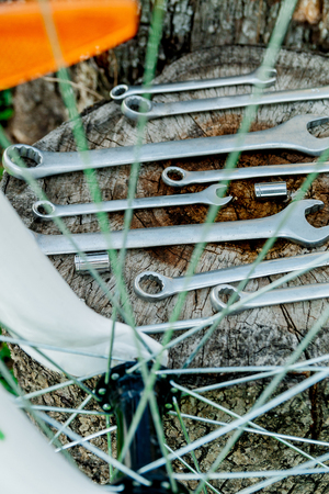 Bike repair tools on wooden background. bicycle repairing.