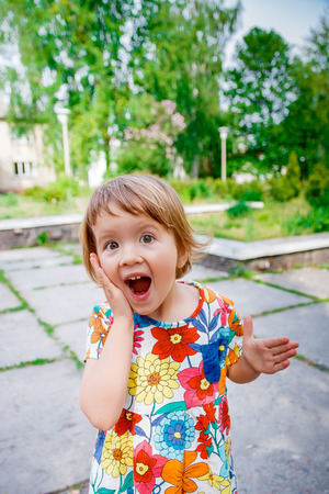 Surprised baby girl outside. Happy little girl screaming Surprised baby girl outside. Happy little girl screaming
