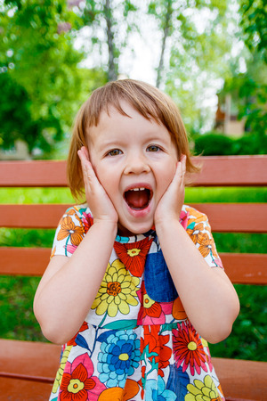 Surprised baby girl outside. Happy little girl screaming Surprised baby girl outside. Happy little girl screaming