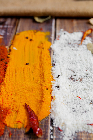 Colourful spices on the table. Various Spices in on wooden background. Spices background. Curry. Coconutの写真素材