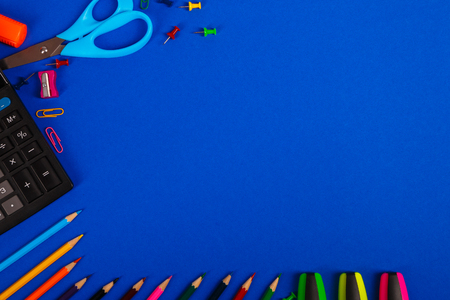 School or office stationery on blue background. Back to School. Frame, copy space. Top view.  suppliesの写真素材