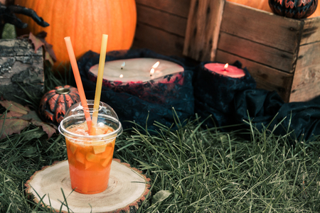 Halloween cocktail with pumpkins decoration on background. Punch for a party. Jack-o-Lantern.の写真素材