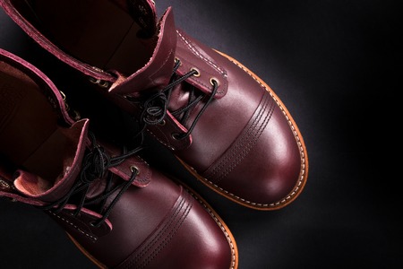 Fashionable mens leather brown shoes on black background. . Men's high boots. Top view.の写真素材