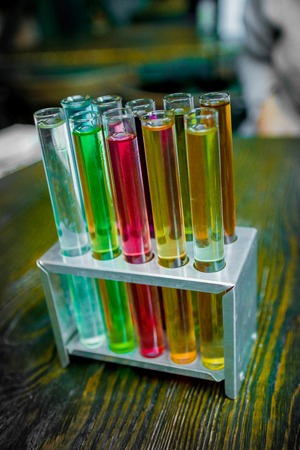 Test tubes in workbench in chemical laboratory on wooden background.