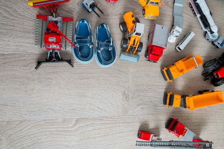 Blue boat shoes for boy near set of car toy. Top view. Frame. Copy space.の写真素材