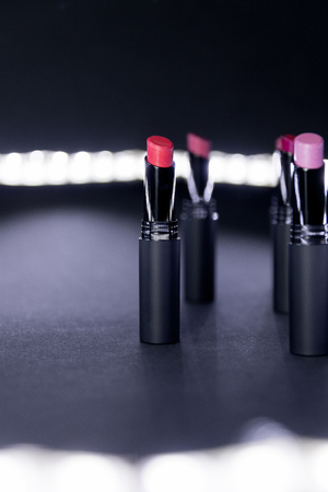 Set of matte Lipstick in red and natural colors on white and black background. Fashion colorful lipsticks. Professional makeup and beauty.の写真素材