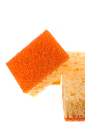 A yellow and orange kitchen sponge isolated on white background.の写真素材