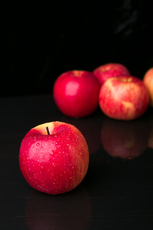 Red apples on black background. Wet. Close upの写真素材