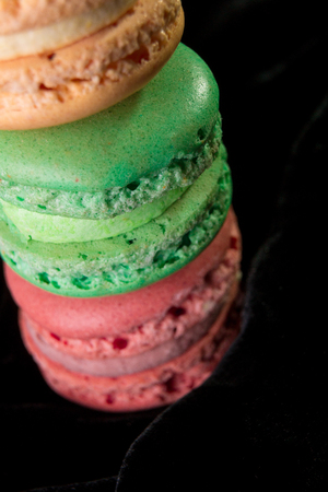 Macaroons on black velvet background. Isolated. French dessert.Close upの写真素材
