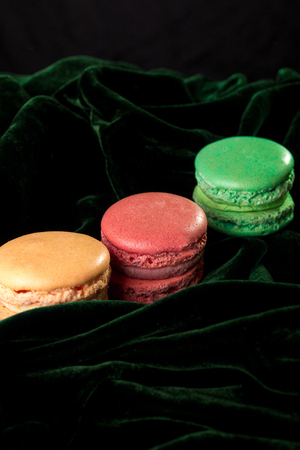 Macaroons on black velvet background. Isolated. French dessertの写真素材
