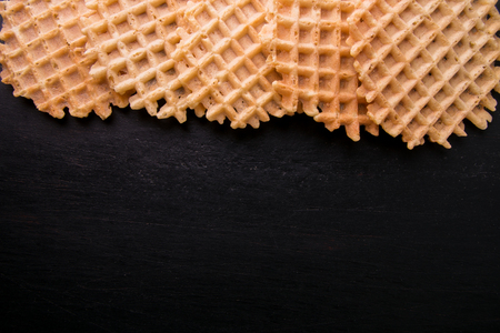 Belgian waffles on black background. Top view. Copy space. Frameの写真素材
