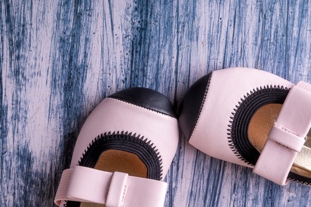 Baby girl pink shoes on colored background. Top view. Copy spaceの写真素材