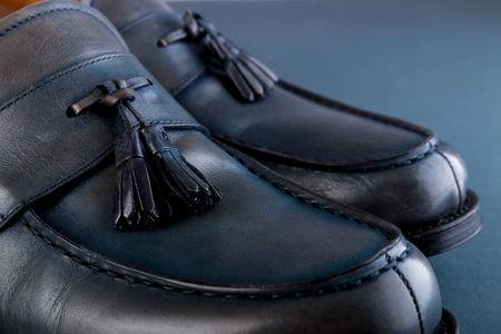 Blue loafer shoes on blue background. One pair. Close upの写真素材