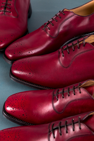 Red oxford shoes on blue background. Three pair  brogues. Close upの写真素材