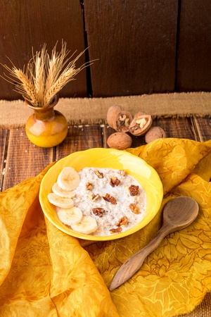 Healthy breakfast, bowl of granola with yogurt and fresh fruits on rustic background, top viewの写真素材
