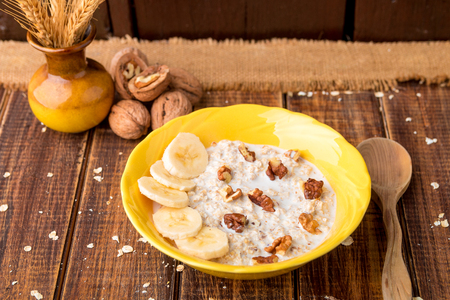 Healthy breakfast, bowl of granola with yogurt and fresh fruits on rustic background, top viewの写真素材