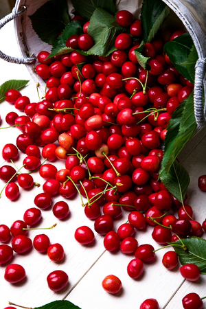 Scattered cherry from basket. Cherries in basket on white background. Healthy, summer fruit....