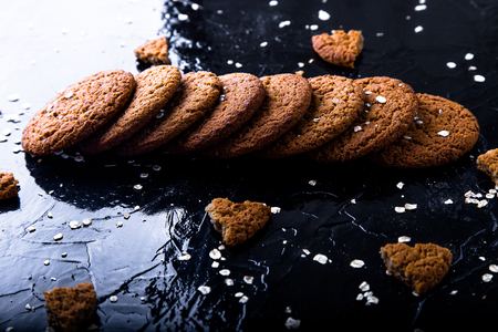 Oatmeal cookies on black background.  Towel of oat cookiesの写真素材