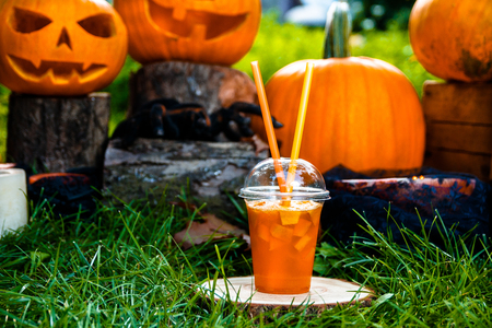 Halloween cocktail with pumpkins decoration on background. Punch for a party. Jack-o-Lanternの写真素材