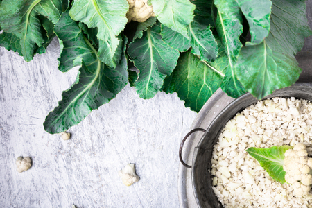 Cauliflower rice in metal bowl on grey background. Top view. Overhead. Copy space. Shredded.の写真素材