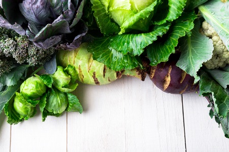 Various of Cabbage Broccoli Cauliflower. Assorted of Cabbages on white wooden background. Flat layの写真素材