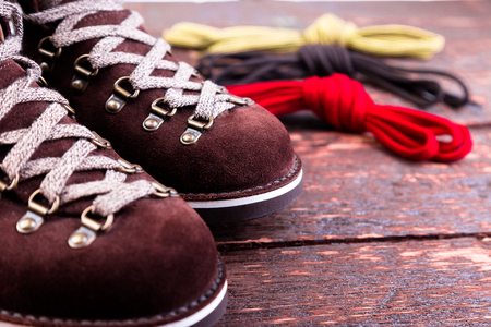 Brown man suede boots and shoelaces on wooden background. Autumn or winter shoes. Macroの写真素材