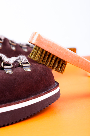 Brown man suede boots with brush. Macro. Clean shoes.の写真素材