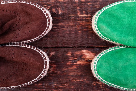 Green and brown suede espadrille shoes on wooden backgroundの写真素材