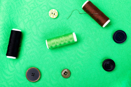 Items for sewing clothes. Sewing buttons, spools of thread and cloth. Top viewの写真素材