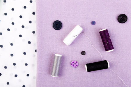Items for sewing clothes. Sewing buttons, spools of thread and cloth. Top viewの写真素材