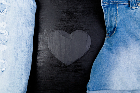 Denim. Jeans texture background. Valentine Day. Black Stone Slate heart. Copy spaceの写真素材