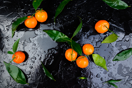 Fresh tangerines Peeled and sliced orange on a Black Background. Citrus background.の写真素材