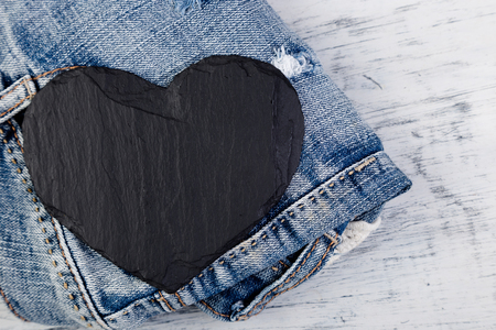 Denim. Jeans texture background. Valentine Day. Black Stone Slate heart. Copy spaceの写真素材