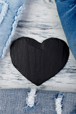 Denim. Jeans texture background. Valentine Day. Black Stone Slate heart. Copy spaceの写真素材