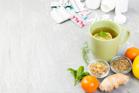 Alternative remedies and traditional pills to treat colds and flu. Natural medicine vs conventional medicine concept. Copy space.の写真素材