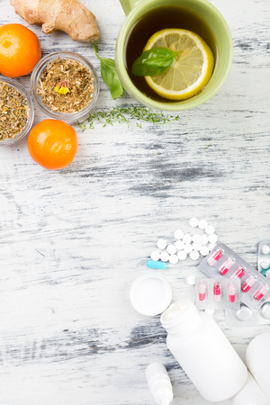 Alternative remedies and traditional pills to treat colds and flu. Natural medicine vs conventional medicine concept. Copy space.の写真素材
