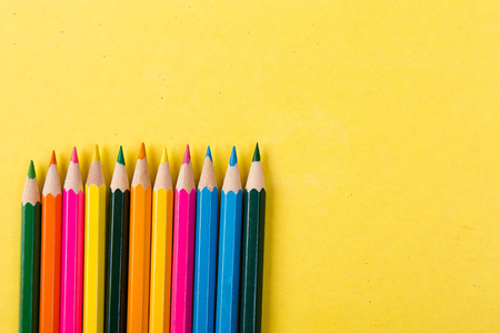 Colorful pencils on yellow background. Flat lay. Copy space.の写真素材
