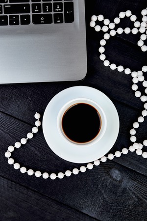 Modern women workplace with notebook or laptop, cup of coffee. Still life, business, office supplies or education concept. Flat lay. Top view.の写真素材