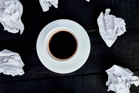 Concept in search ideas. Creased paper of idea and cup of coffee. Still life, business or education...