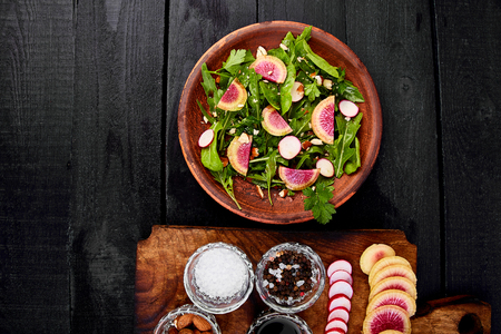 Ingredient and salad brown plate . mix leaf, Radish, Lettuce, mangold, parsley, dill, arugula, almond, salt, tasty, balsamic pepper Healthy diet Clear food Vegan Flat lay Copy spaceの写真素材